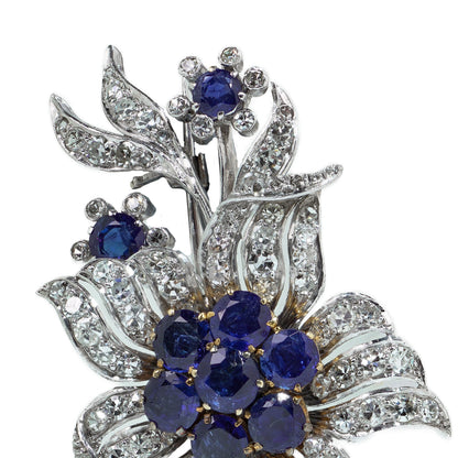 A flower spray brooch set with sapphires and diamonds, set in palladium