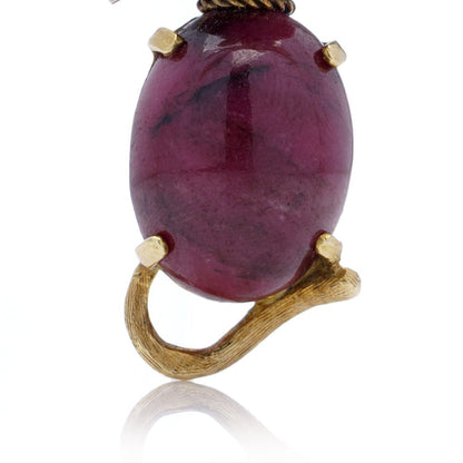 Vintage gold cat-shaped brooch with ruby eyes.