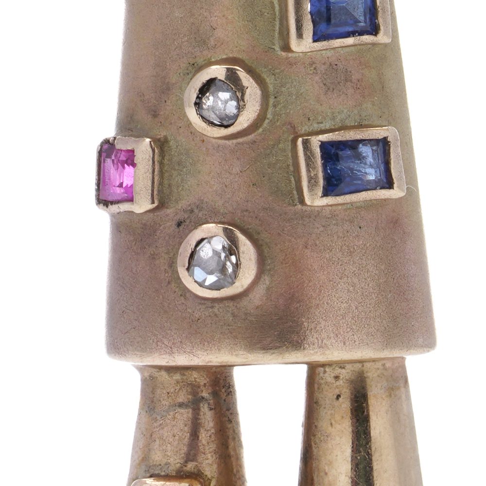 Vintage gold scarecrow brooch with gemstones.