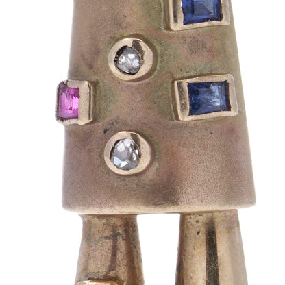 Vintage gold scarecrow brooch with gemstones.