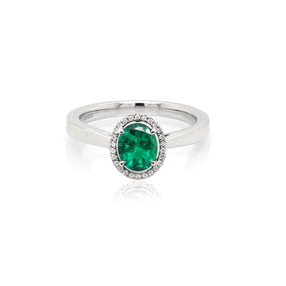 Emerald and diamond cluster ring in white gold.