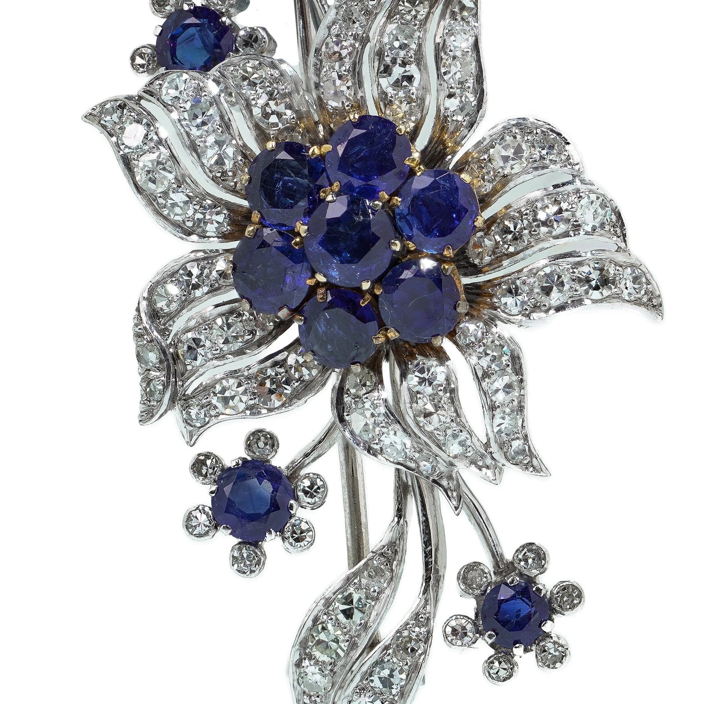 A flower spray brooch set with sapphires and diamonds, set in palladium