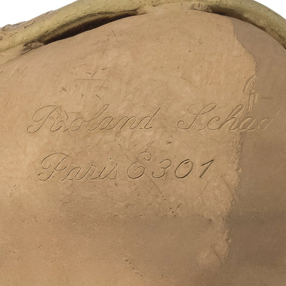 Close-up of engraved text on a yellow gold piece reading Roland Schad Paris E301