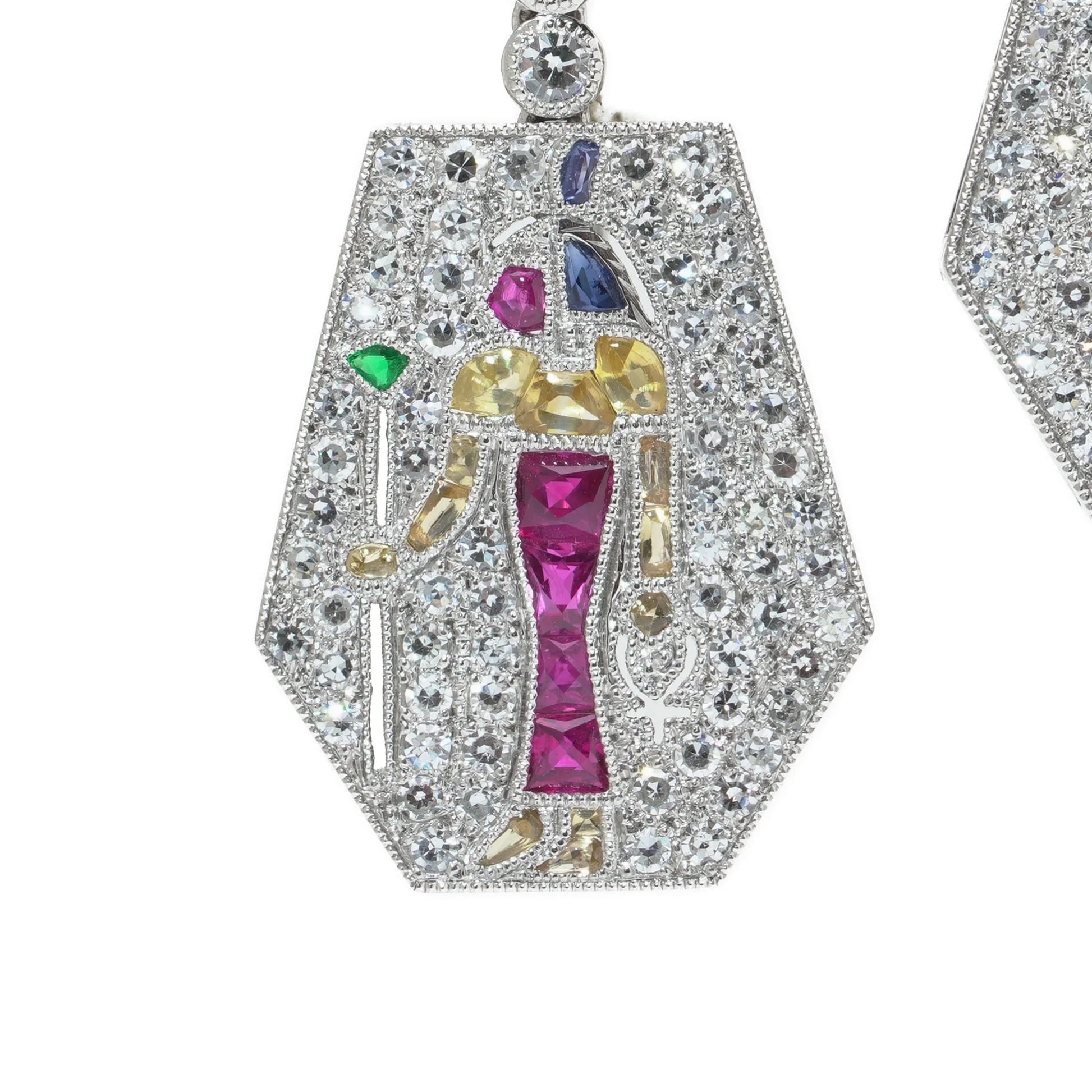 A pair of Eye of Horus drop earrings set with diamonds, rubies, emeralds, blue sapphires and yellow sapphires, in platinum