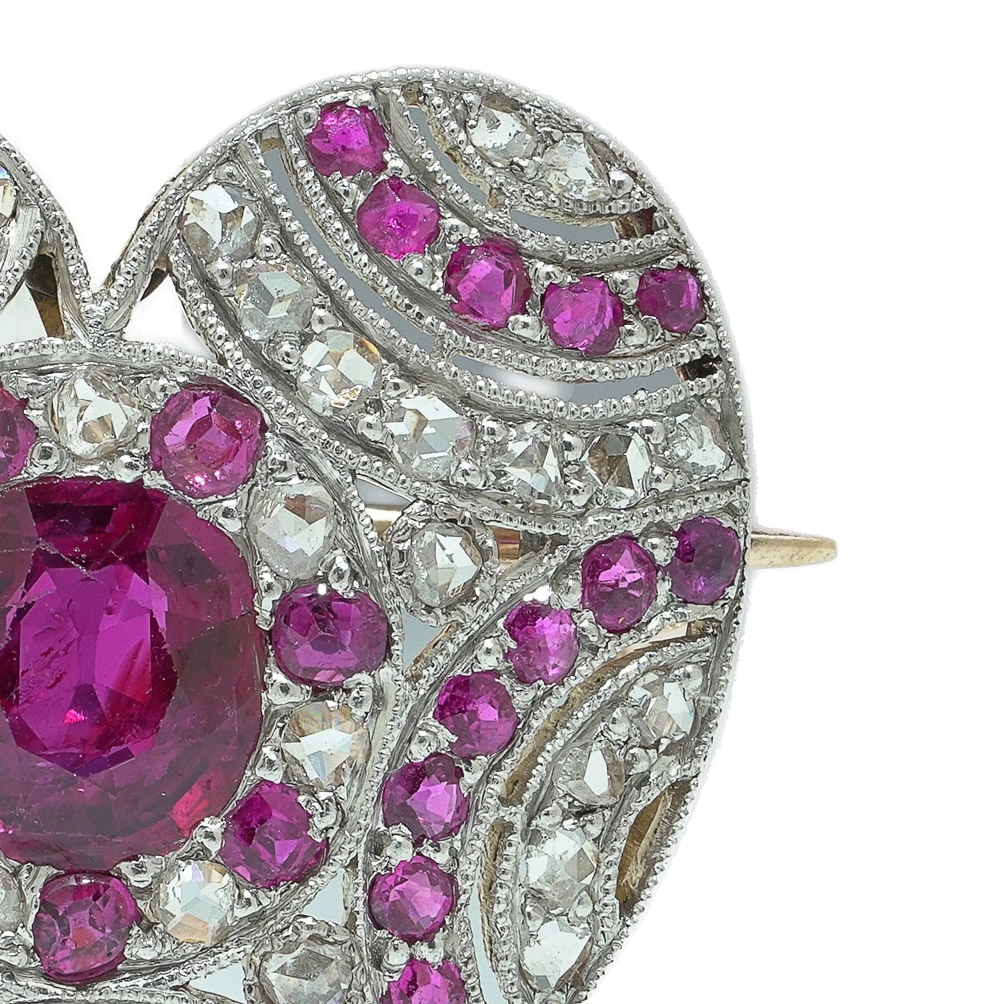 A heart shaped brooch set with rubies and diamonds, in platinum and gold