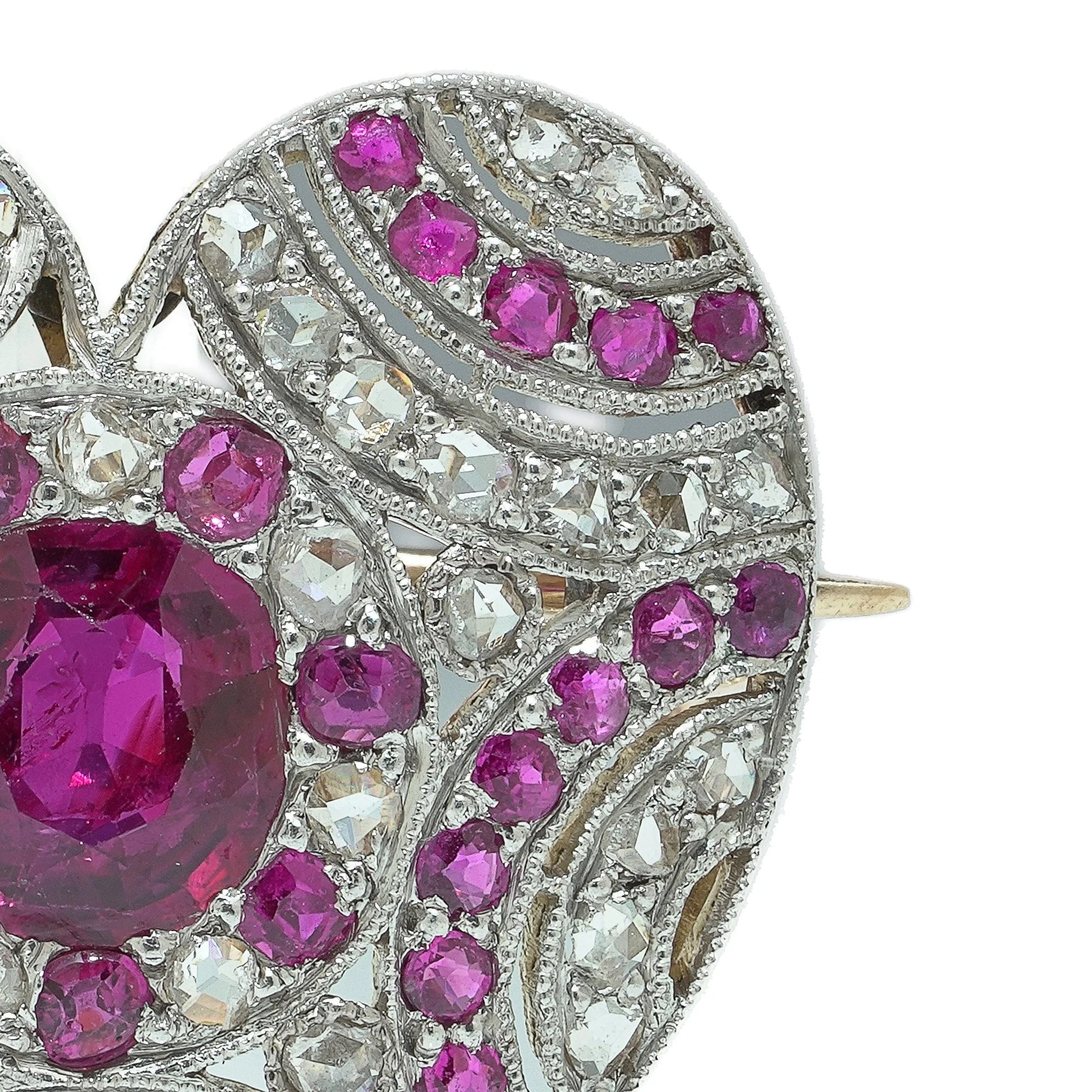 A heart shaped brooch set with rubies and diamonds, in platinum and gold