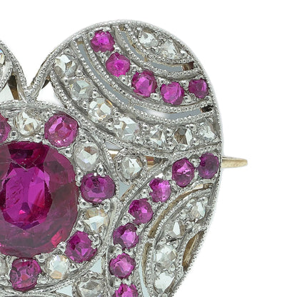 A heart shaped brooch set with rubies and diamonds, in platinum and gold