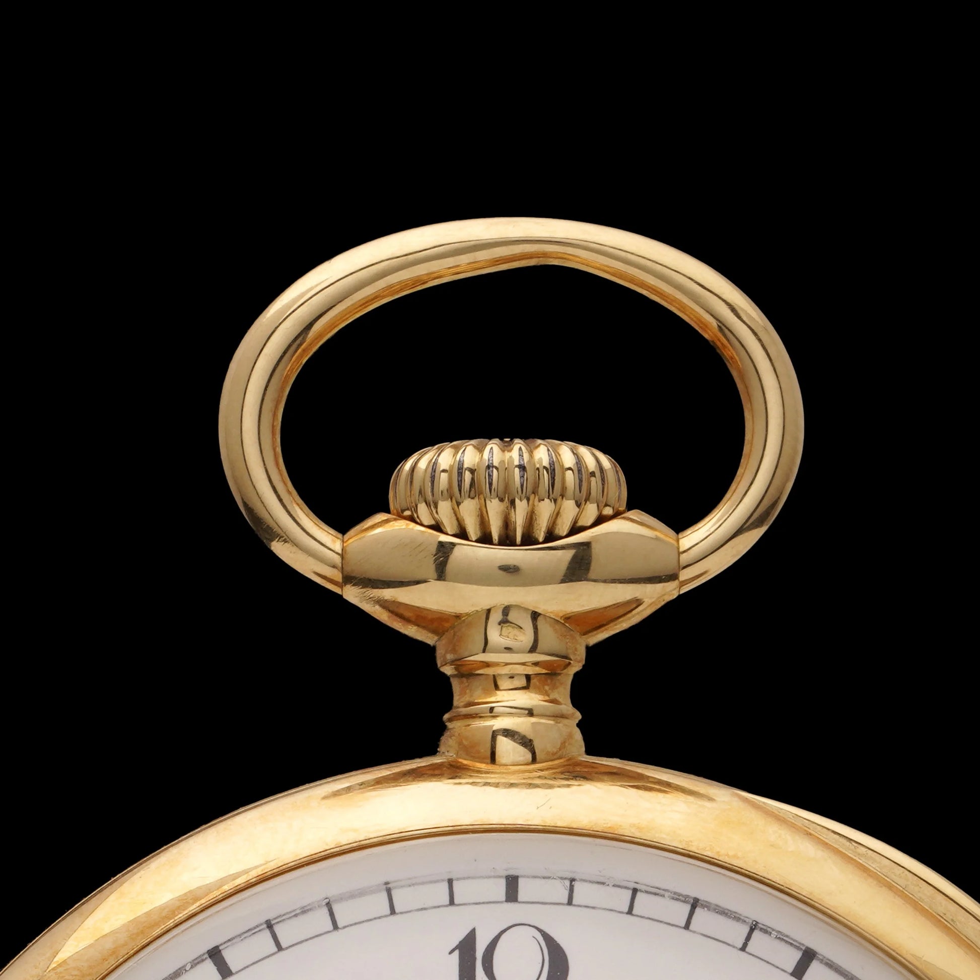 A yellow gold crown on a Vacheron & Constantin pocket watch with a white dial and black Arabic numbers, on a black background