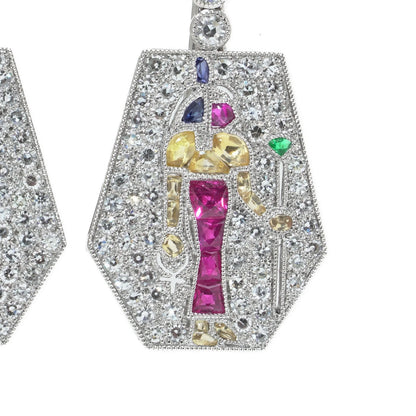 A pair of Eye of Horus drop earrings set with diamonds, rubies, emeralds, blue sapphires and yellow sapphires, in platinum