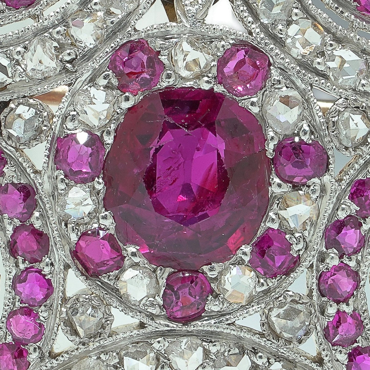 Close-up of a heart shaped brooch set with rubies and diamonds, in platinum and gold