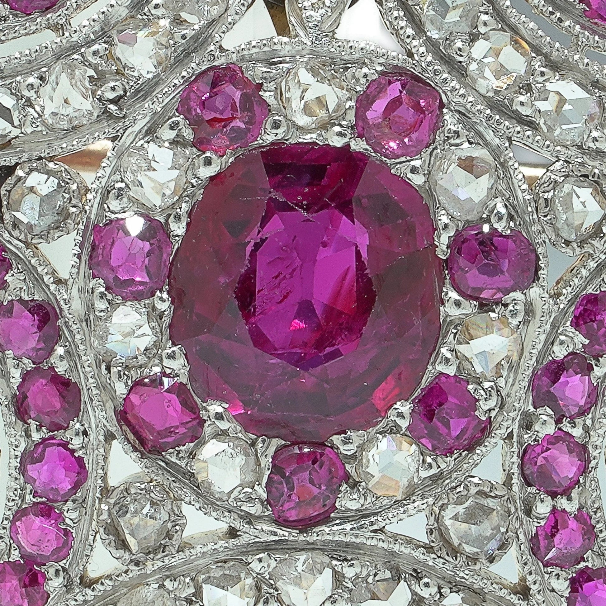Close-up of a heart shaped brooch set with rubies and diamonds, in platinum and gold