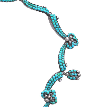 An antique turquoise bead and pearl fancy necklace, on a white background