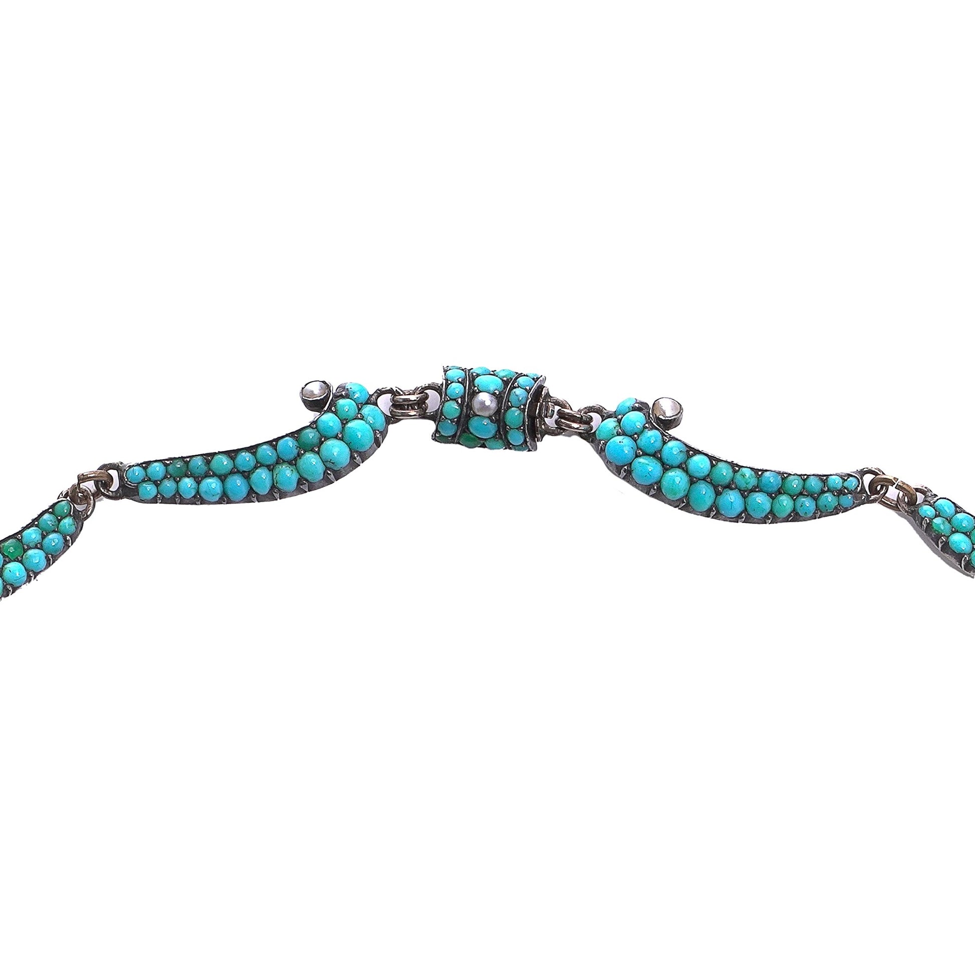 An antique turquoise bead and pearl fancy necklace, with a barrel shaped clasp, on a white background