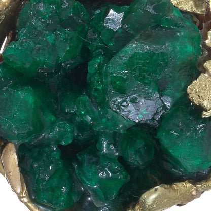 A yellow gold free-form pendant with a rough cut emerald, on a white background