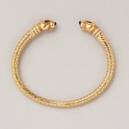 Vintage Cartier Panthere Gold Bangle Bracelet, 18ct yellow gold bangle bracelet with a panther head at both ends with sapphire eyes, onyx noses and diamond-set collars