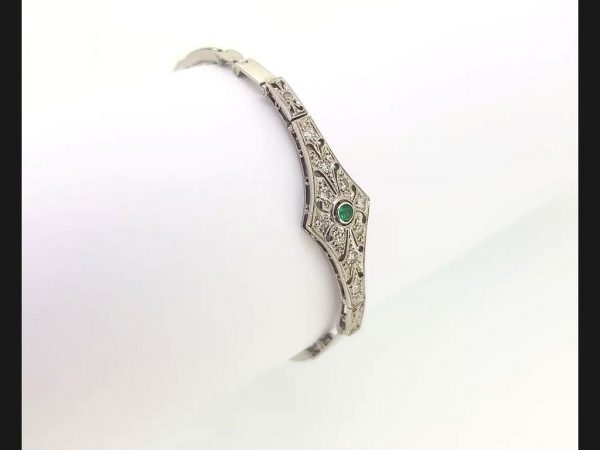 Vintage Emerald and Diamond Bracelet reminiscent of the Art Deco style; Diamond bracelet with central round cut emerald, on an expandable strap