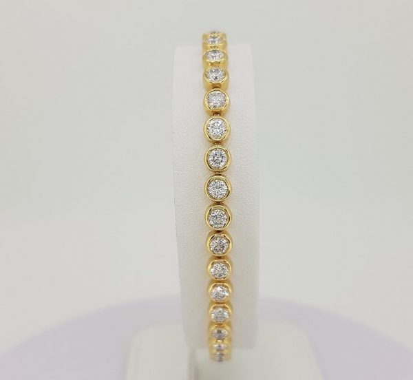 Tennis line bracelet yellow gold diamond line rubover bezel setting