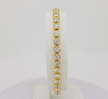 Tennis line bracelet yellow gold diamond line rubover bezel setting