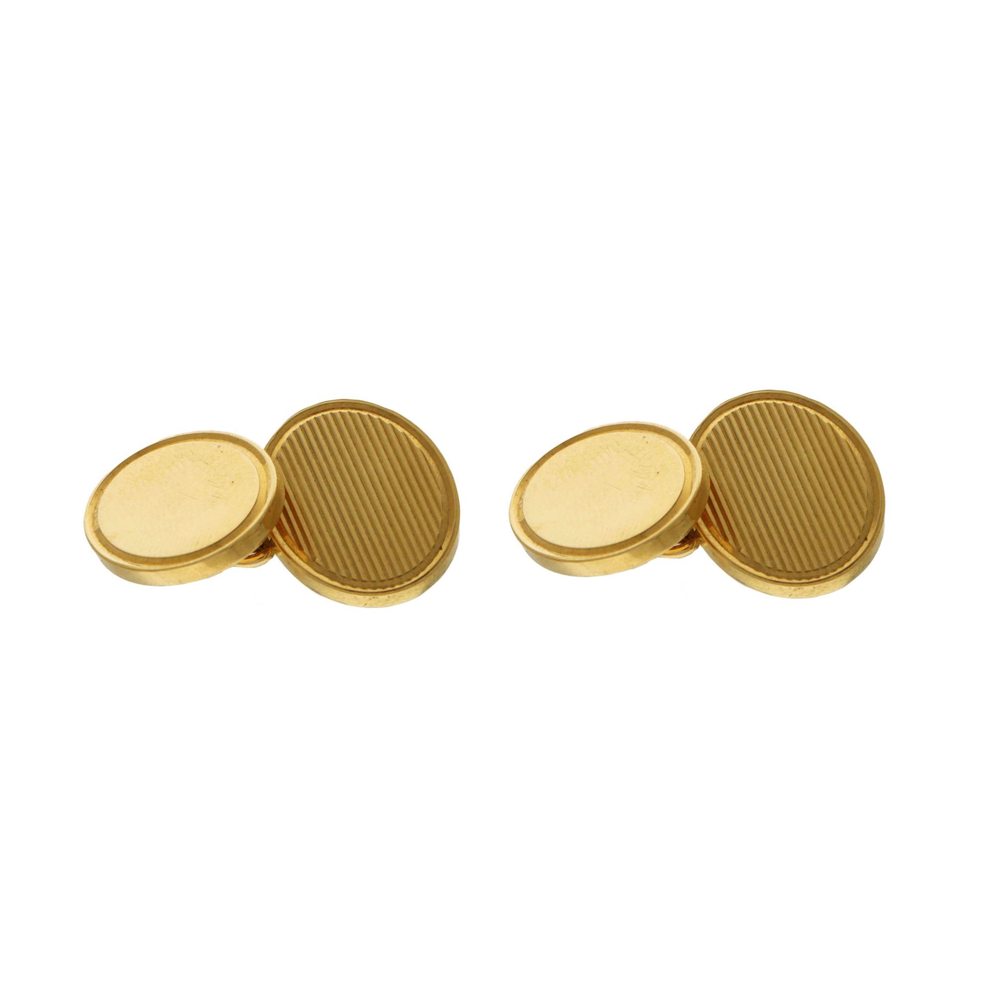 Pair of yelow gold oval cufflinks with textured design on a white background
