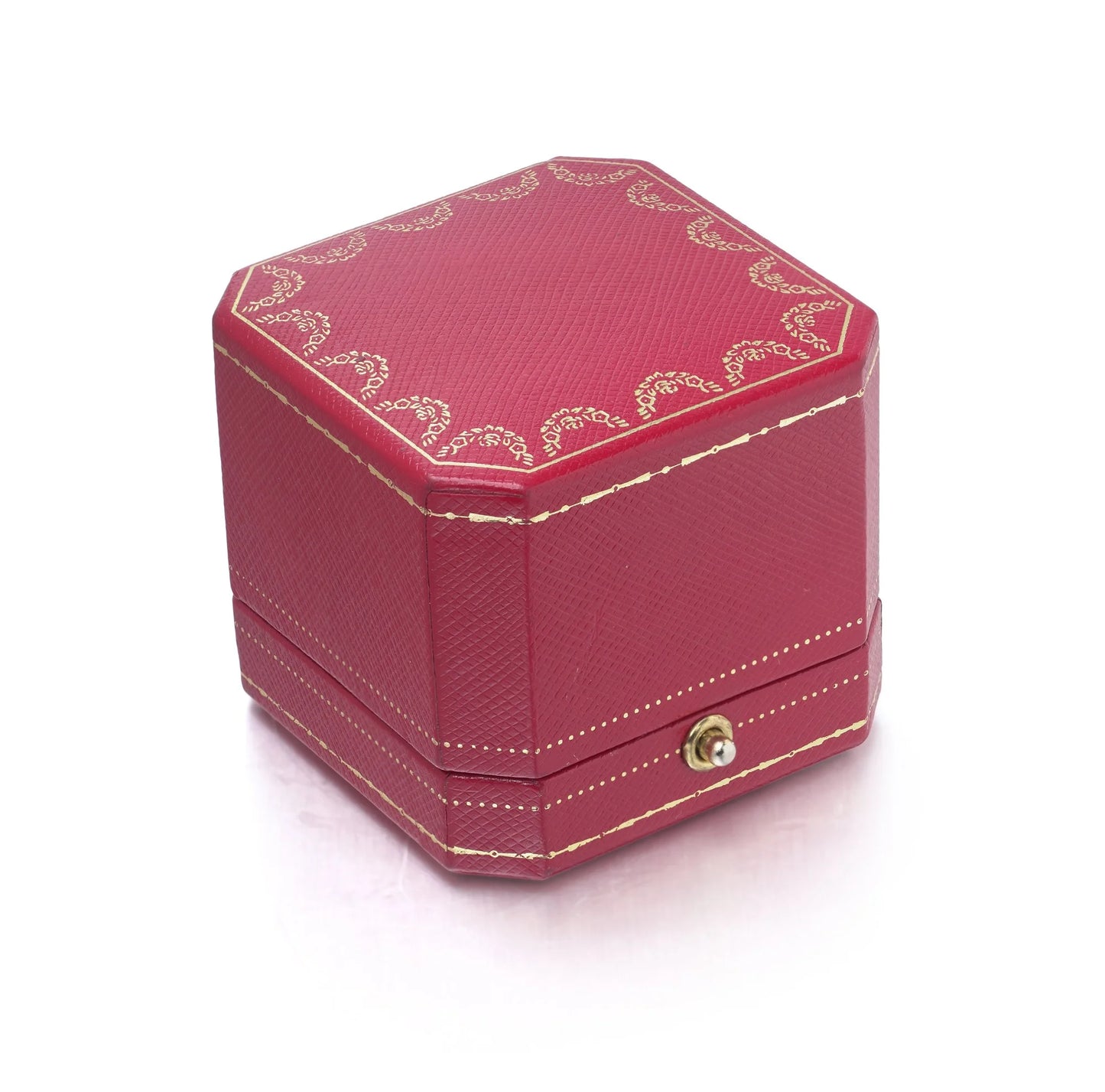 A red and gold leather ring box