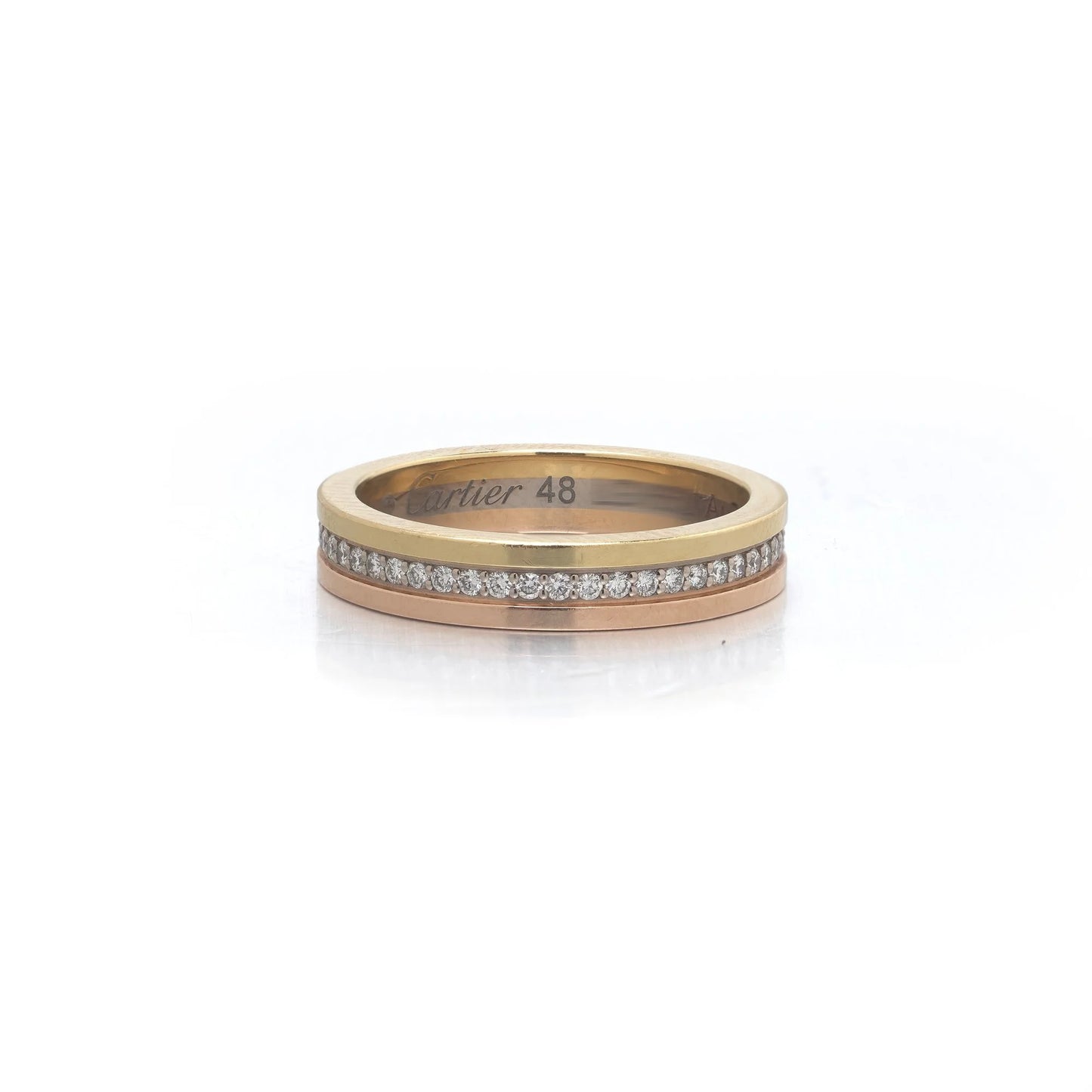 A diamond band in yellow, rose and white gold, stamped Cartier