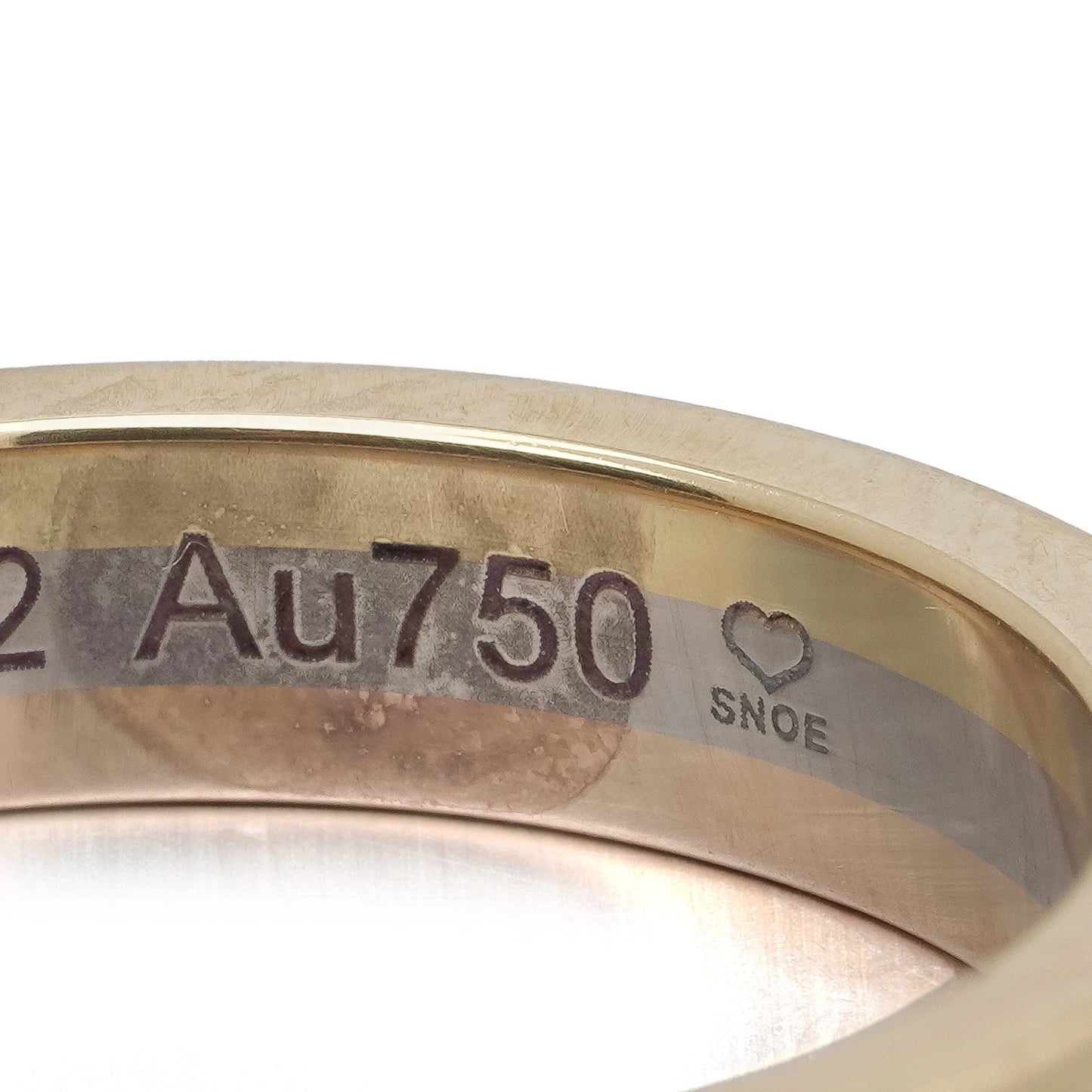 Close-up of a Au750 stamp inside a gold ring shank