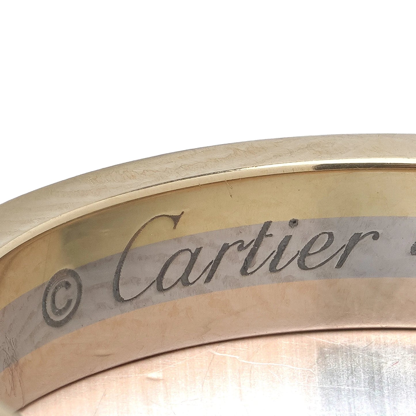 Close-up of a Cartier stamp inside a gold ring shank