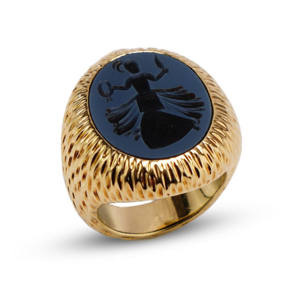 Gold signet ring with an oval carved sardonyx intaglio.