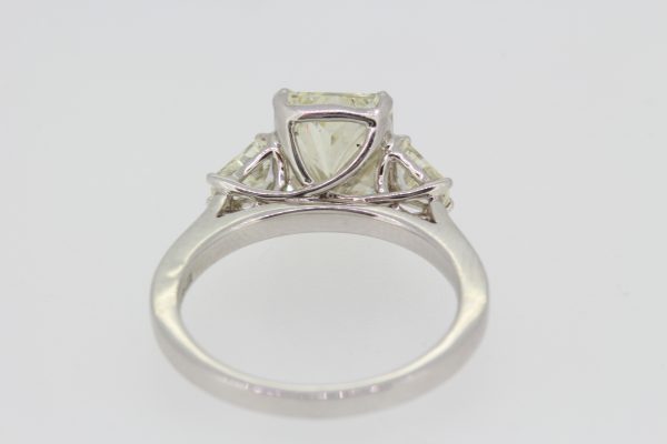 Radiant Emerald Cut Diamond Engagement Ring in Platinum; central 3.02ct emerald radiant-cut diamond, claw set and flanked by 0.43cts shield-shaped trapeze-cut diamonds