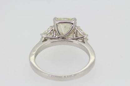 Radiant Emerald Cut Diamond Engagement Ring in Platinum; central 3.02ct emerald radiant-cut diamond, claw set and flanked by 0.43cts shield-shaped trapeze-cut diamonds