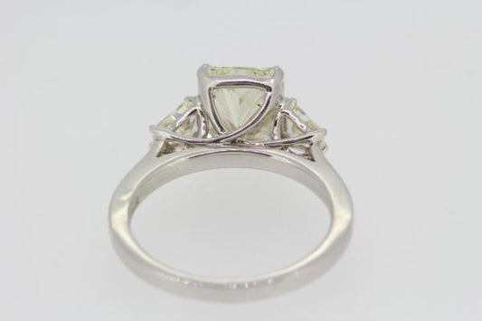 Radiant Emerald Cut Diamond Engagement Ring in Platinum; central 3.02ct emerald radiant-cut diamond, claw set and flanked by 0.43cts shield-shaped trapeze-cut diamonds