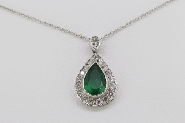 Pear Cut Emerald and Diamond Cluster Pendant; central 1.70ct pear-shaped faceted emerald within a diamond surround, suspended from a diamond-set bale, in 18ct white gold, on an 18ct white gold chain