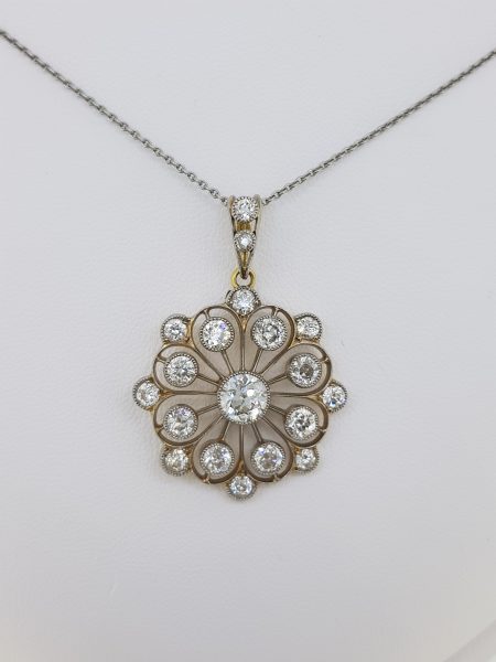 Diamond Floral Openwork Cluster Pendant in Platinum; openwork floral frame crafted from platinum set with 4 carats of brilliant-cut diamonds