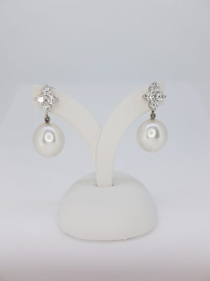 South Sea Pearl and Diamond Drop Earrings; featuring 13.5mm pearls suspended from 1.04ct diamond-set quatrefoil tops, in 18ct white gold