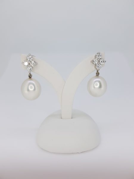 South Sea Pearl and Diamond Drop Earrings; featuring 13.5mm pearls suspended from 1.04ct diamond-set quatrefoil tops, in 18ct white gold