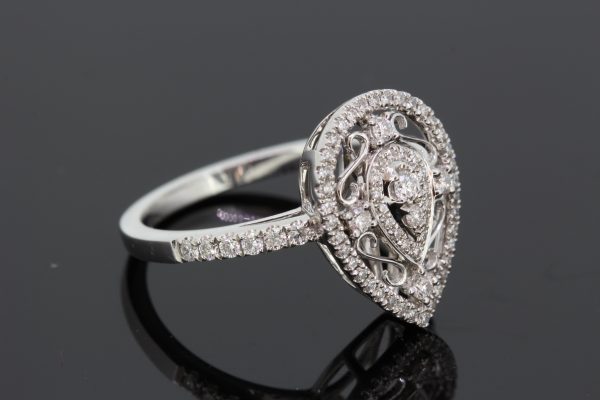 Pear Shaped Diamond Cluster Dress Ring, 0.41 carats, two central round brilliant-cut diamonds within pear-shaped diamond border, surrounded by white gold scrolls with diamond accents, all within an outer pear-shaped diamond-set halo, in 18ct white gold with diamond set shoulders