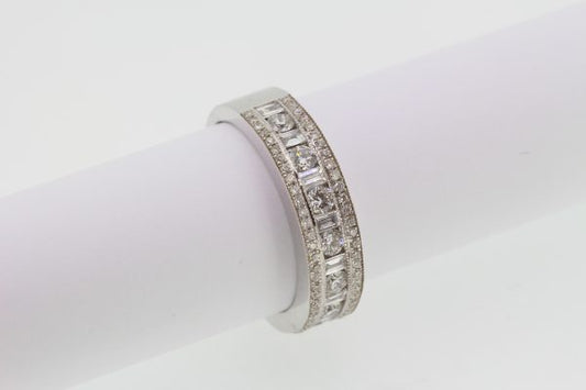 Channel Set Diamond Ring; channel set brilliant and baguette-cut diamonds flanked by rows of pave-set diamonds, 1.00 carat total, in 18ct white gold