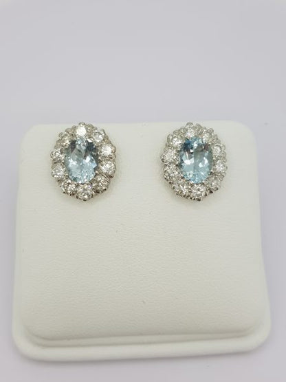 Aquamarine and Diamond Oval Cluster Stud Earrings; featuring 2.50cts oval facetted aquamarines within 1.90ct diamond surrounds, in 18ct white gold