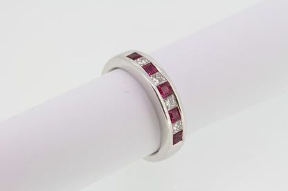 Princess Cut Ruby and Diamond Half Eternity Ring; channel-set with alternating square-cut rubies and princess-cut diamonds, in 18ct white gold