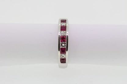 Princess Cut Ruby and Diamond Half Eternity Ring; channel-set with alternating square-cut rubies and princess-cut diamonds, in 18ct white gold