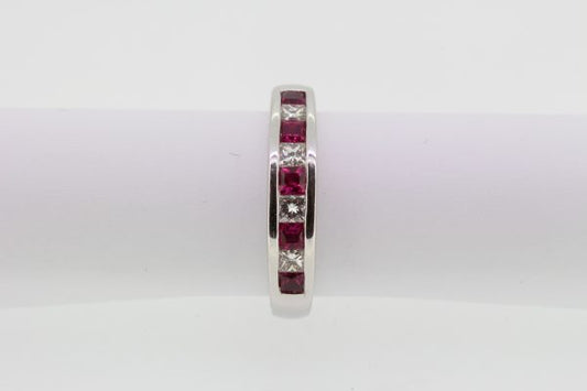Princess Cut Ruby and Diamond Half Eternity Ring; channel-set with alternating square-cut rubies and princess-cut diamonds, in 18ct white gold