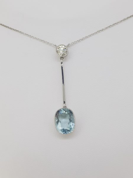 Aquamarine and Diamond Drop Pendant; featuring a 5ct cushion-shaped oval aquamarine suspended from a 0.60ct brilliant-cut diamond via a gold bar, 18ct white gold