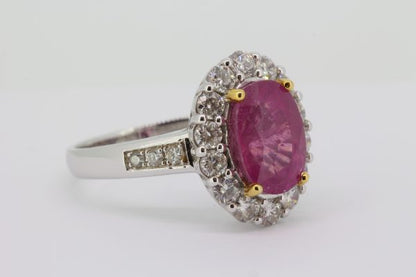 Pink Sapphire and Diamond Oval Cluster Ring; central 4.17 carat oval faceted pink sapphire with 0.92cts diamond surround and diamond-set shoulders, in 18ct white gold