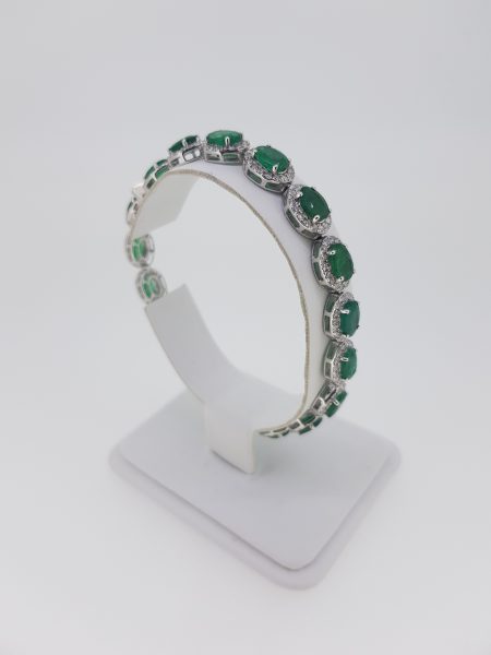 Emerald and Diamond Cluster Bracelet; each cluster features an oval faceted emerald with a diamond surround, in 18ct white gold. Emeralds 13.00 carats. Diamonds 3.20 carats