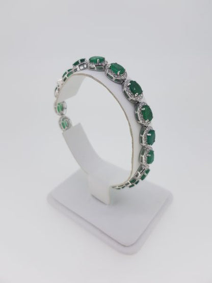 Emerald and Diamond Cluster Bracelet; each cluster features an oval faceted emerald with a diamond surround, in 18ct white gold. Emeralds 13.00 carats. Diamonds 3.20 carats