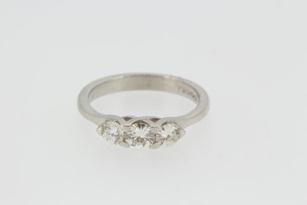 Celtic Diamond Three Stone Ring; featuring three round brilliant-cut diamonds set into a fluid mount reminiscent of a Celtic design, in 18ct white gold