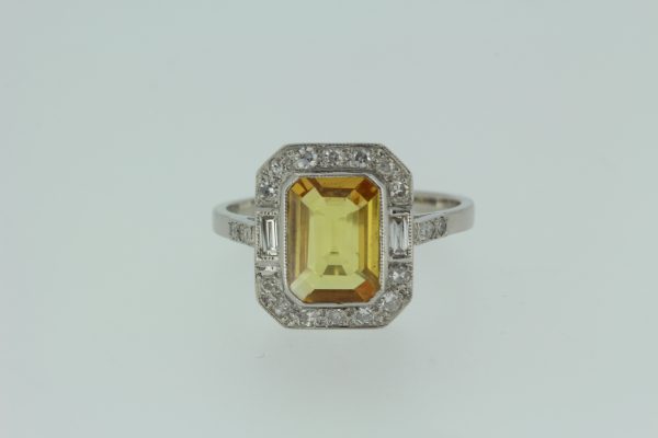 Yellow Sapphire and Diamond Cluster Dress Ring in Platinum; featuring a 2ct emerald-cut yellow sapphire surrounded by 0.40cts baguette and brilliant-cut diamonds