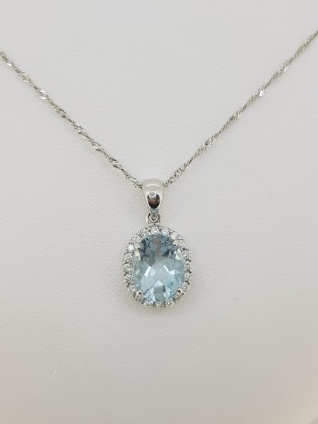 Aquamarine and Diamond Oval Cluster Pendant; central 1.53ct oval aquamarine within a 0.20ct diamond surround, in 18ct white gold