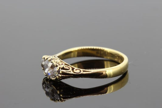 Antique Victorian Old Cut Diamond Three Stone Ring; featuring three old cut diamonds mounted in 18ct yellow gold with pierced under-gallery
