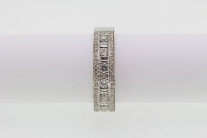 Channel Set Diamond Ring; channel set brilliant and baguette-cut diamonds flanked by rows of pave-set diamonds, 1.00 carat total, in 18ct white gold